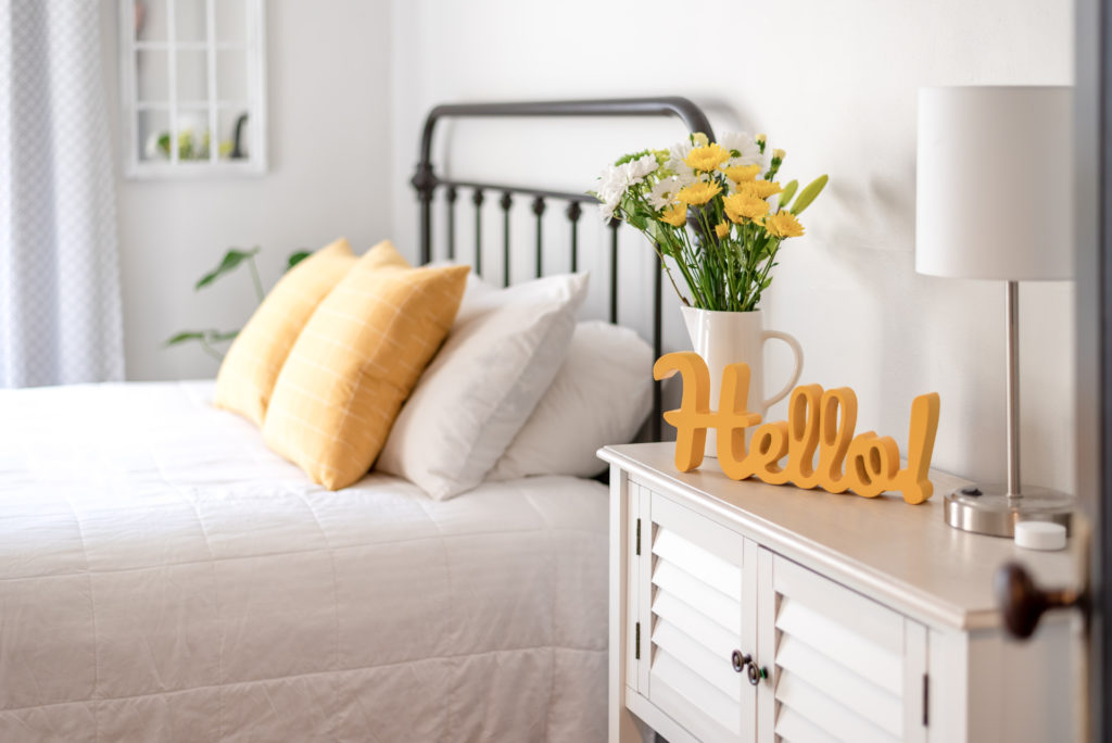 Welcoming bright and clean bedroom scene in an Airbnb rental. 